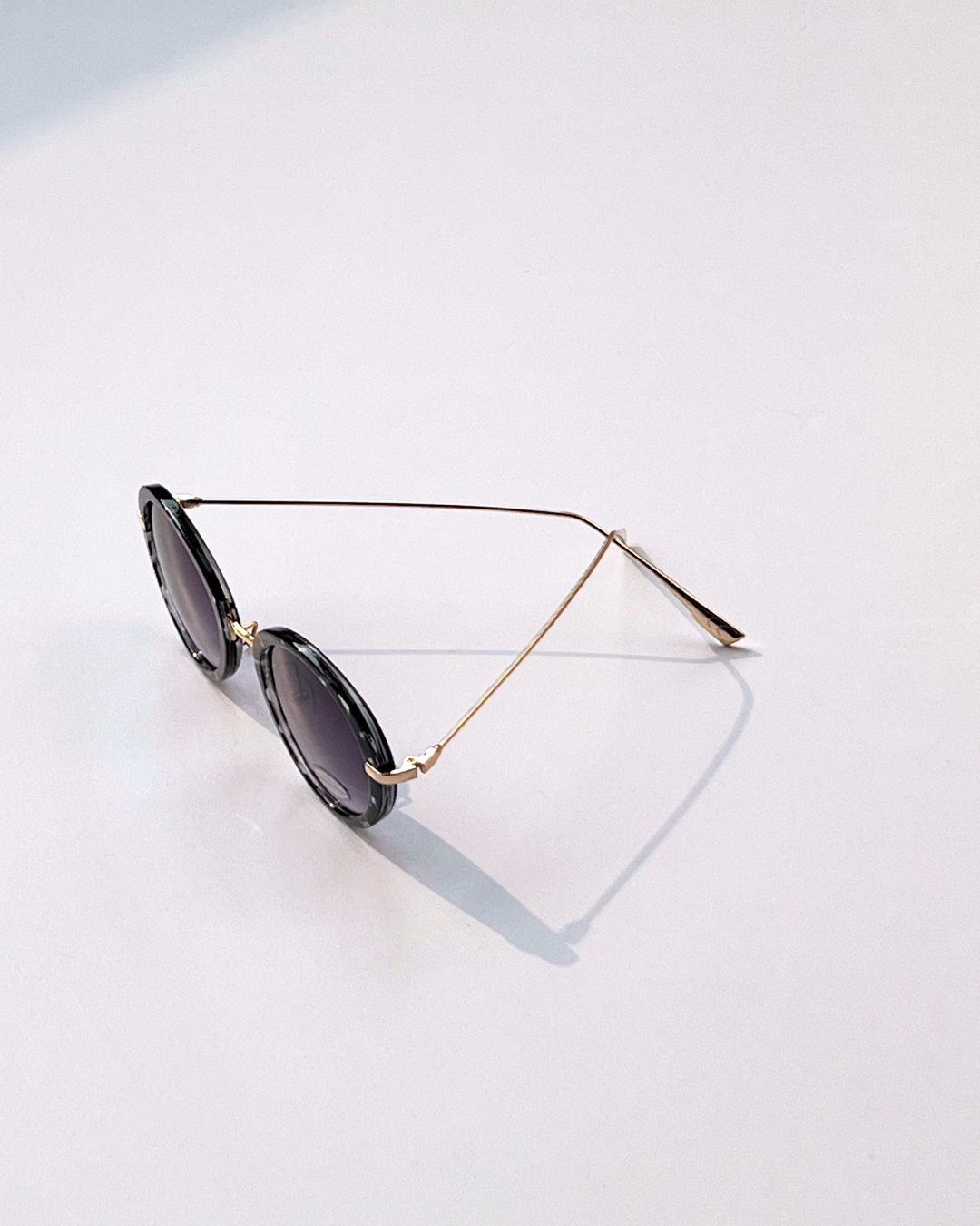 Oval Geometric Sunglasses – Black & White Frame with Purple Lenses
