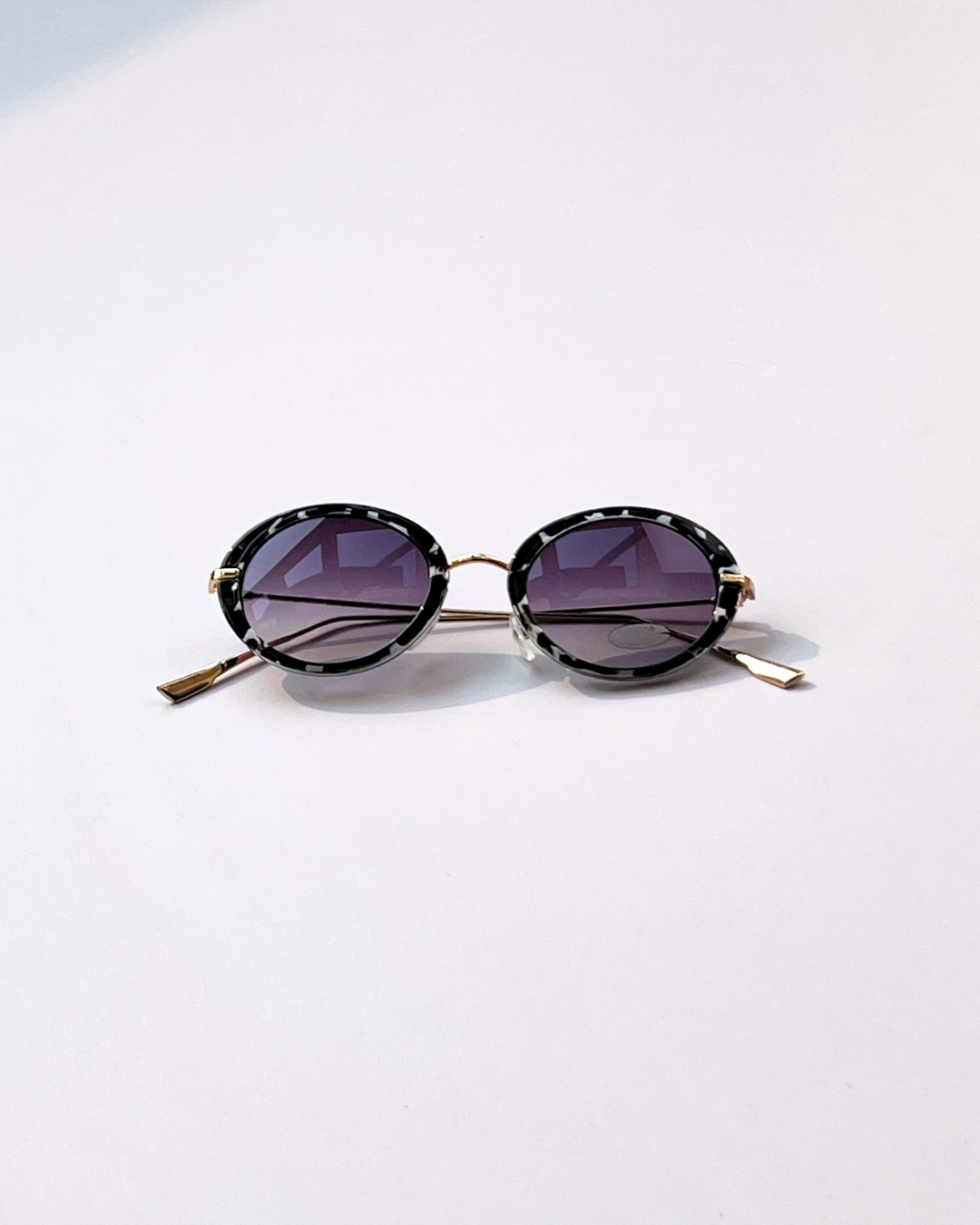 Oval Geometric Sunglasses – Black & White Frame with Purple Lenses